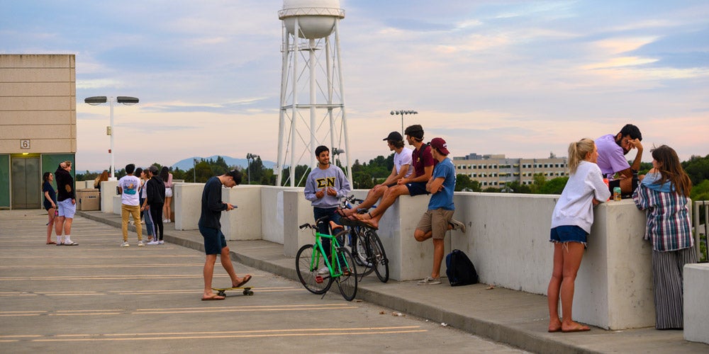 students hanging out on top of a parking structure