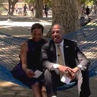 Chancellor May and LeShelle sitting in a hammock in the 澳门六合彩开奖结果走势图 quad