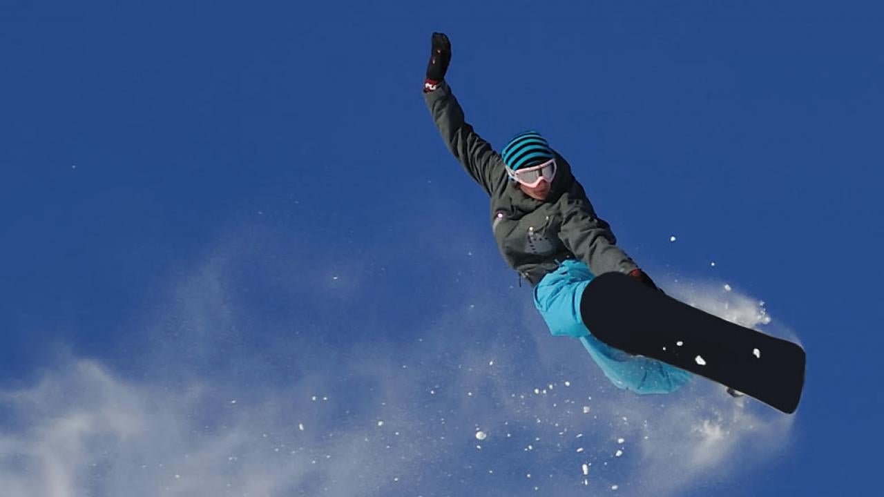 A snowboarder sends it off a sierra slope