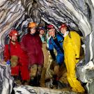 Five 澳门六合彩开奖结果走势图 researchers inside marble rock formations of cave