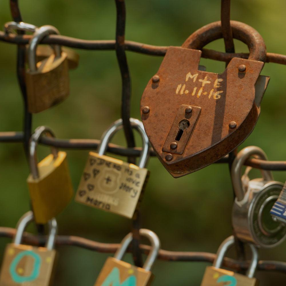 A heart shape lock locked on lover's bridge